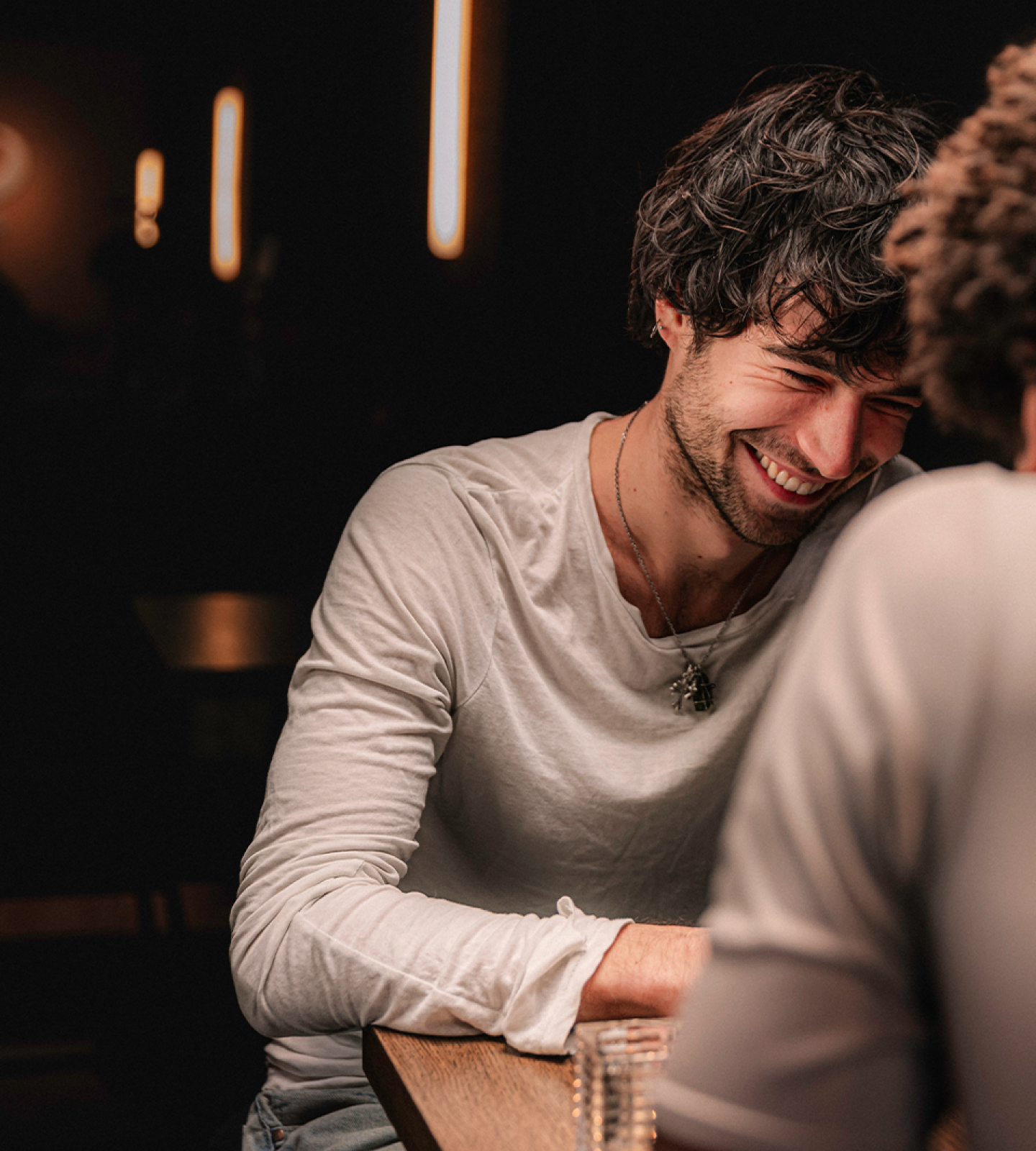 Two people on a date, the man is laughing